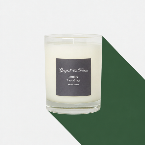 Smoky Earl Gray candle with a hunter-green long shadow